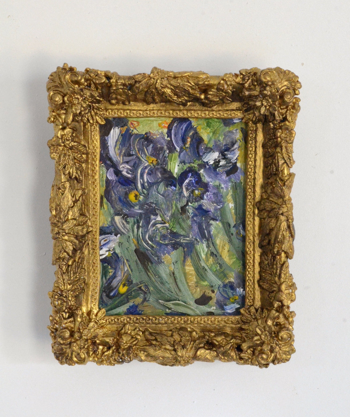 Framed artwork of blue flowers on a white background