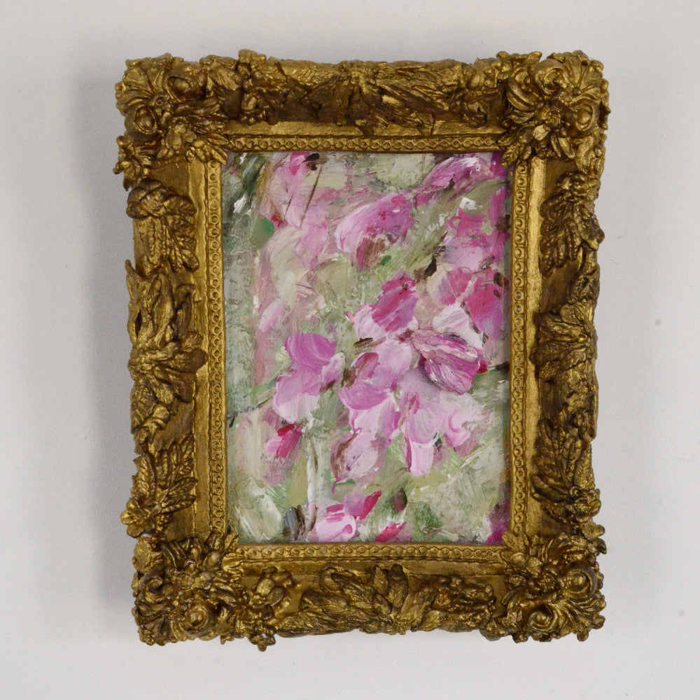 Framed artwork with pink floral design on a white background