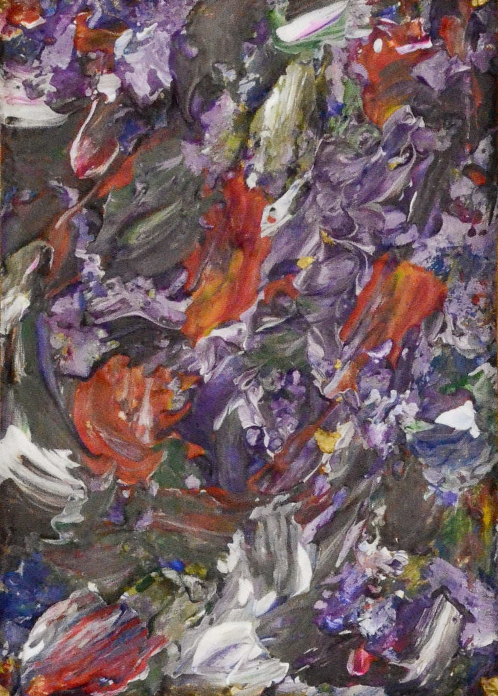 Abstract painting in a gold frame on a white wall