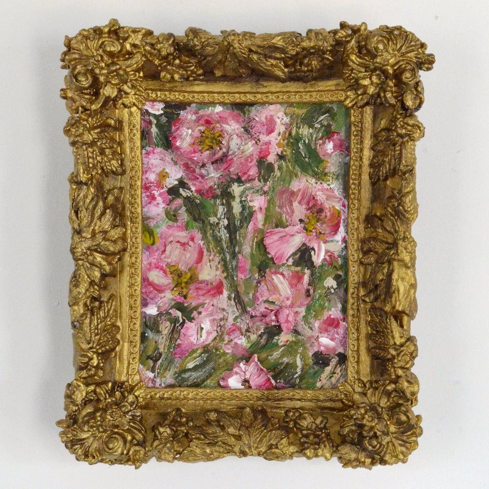 Decorative gold frame with a floral painting on a white background