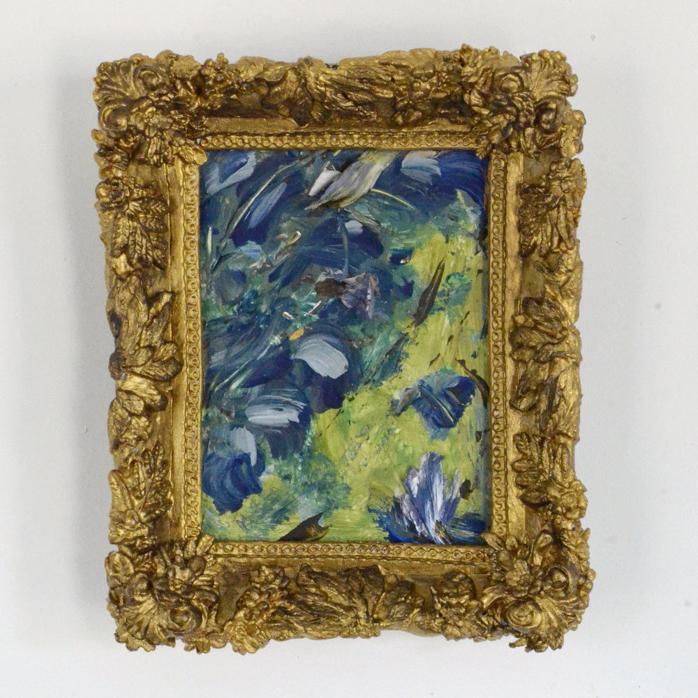 Small oil painting in a decorative gold frame on a white background