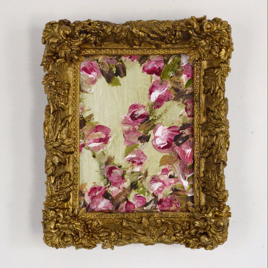Decorative gold frame with floral design on a white background