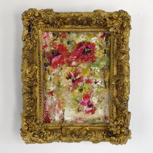 Floral painting in a gold frame on a white background
