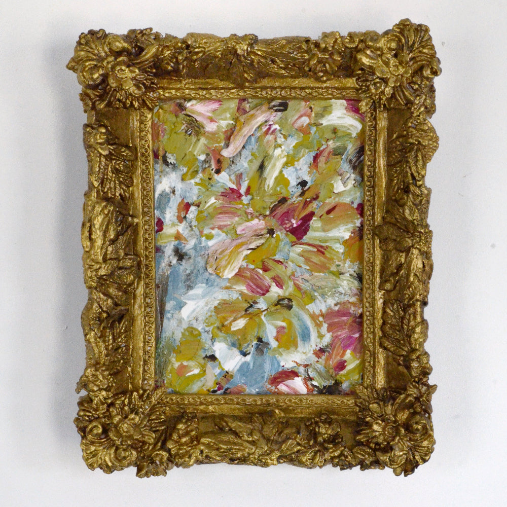 Framed abstract painting with floral patterns on a white wall