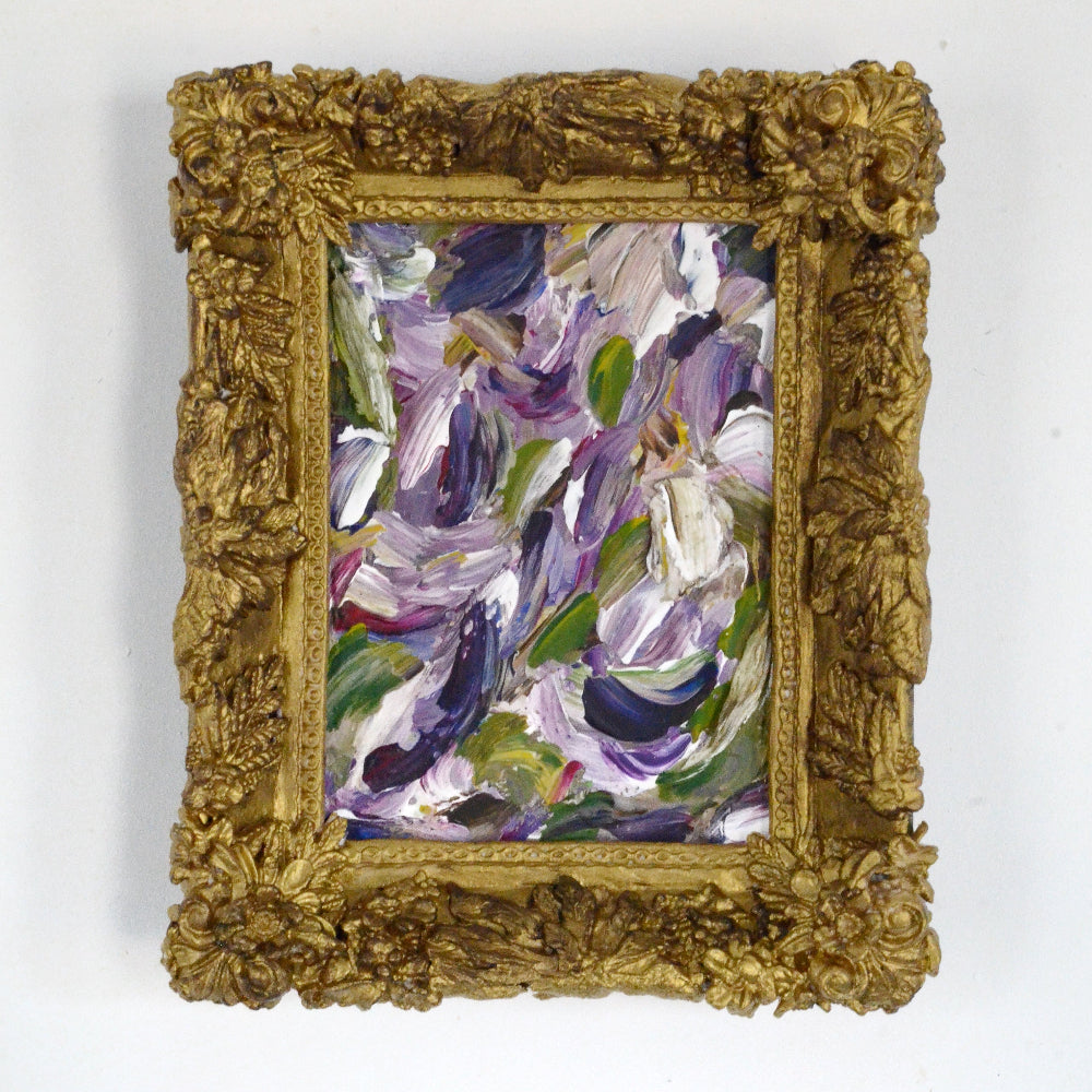 Framed abstract painting with gold frame on a white background