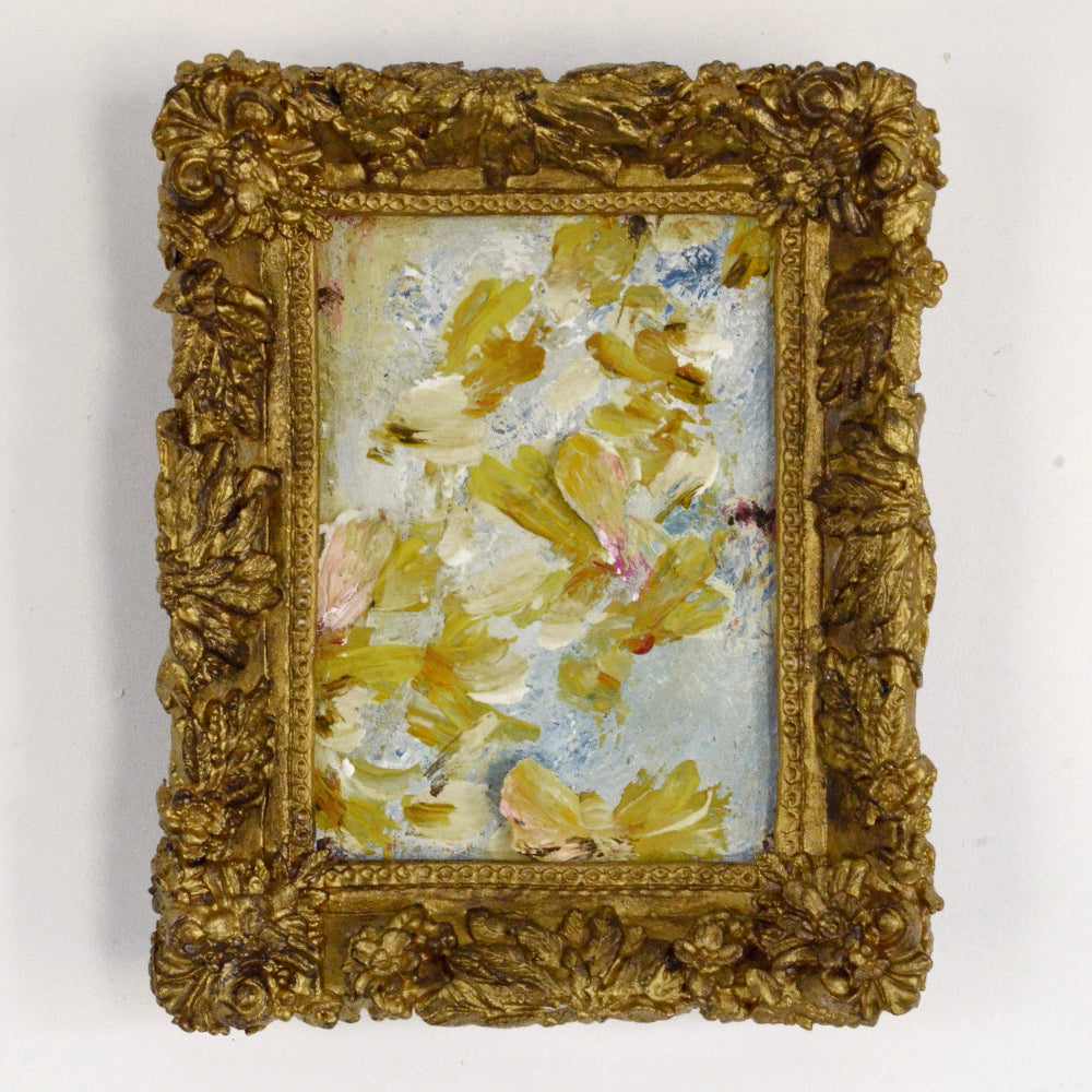 Decorative gold frame with a floral painting on a white background