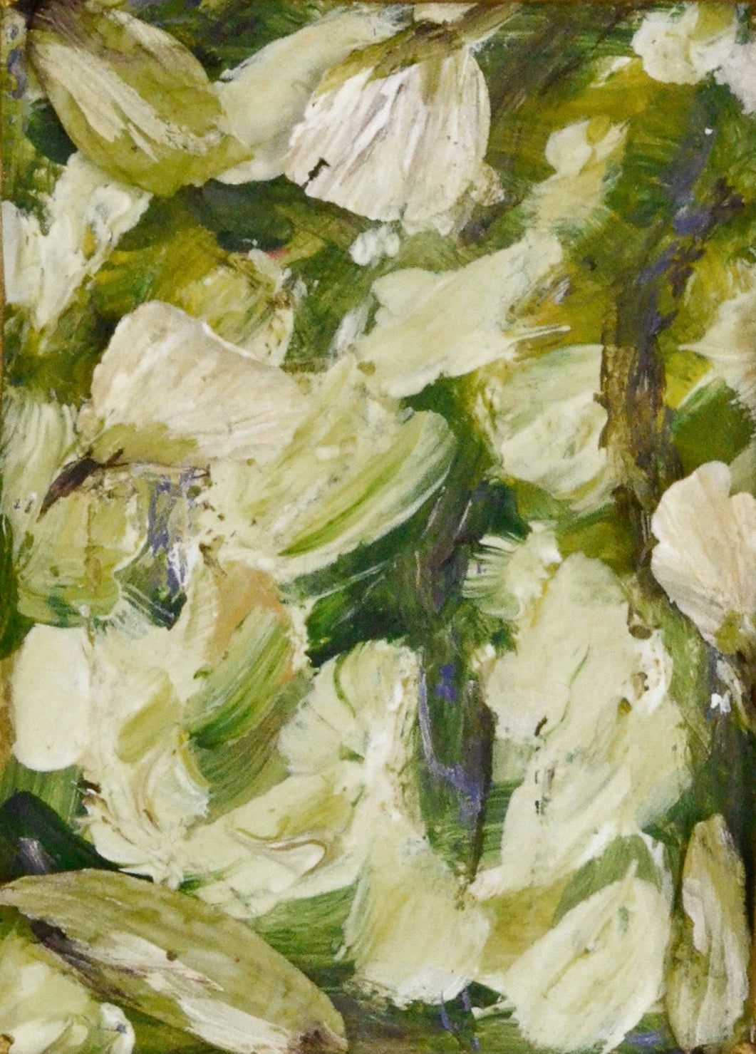 Small oil painting of flowers in a decorative gold frame on a white background